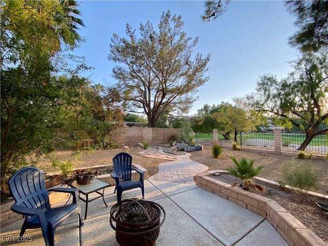 view of patio with fence private yard and a fire pit