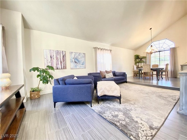 living area with an inviting chandelier, baseboards, and high vaulted ceiling