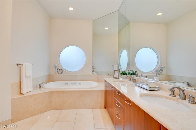 full bath featuring tile patterned flooring, a garden tub, and a sink