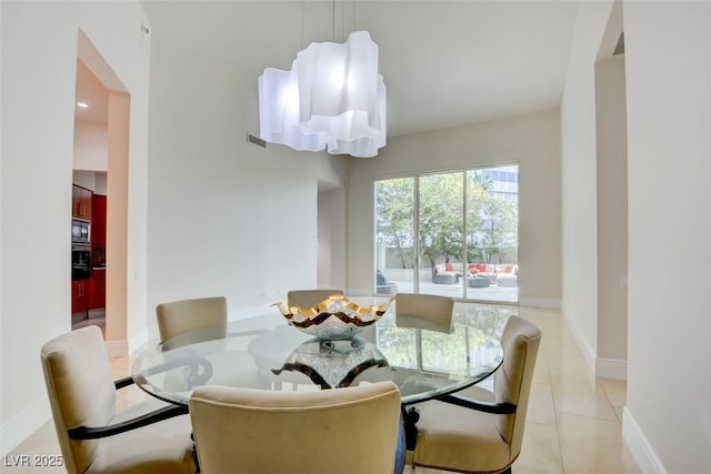 dining space featuring light tile patterned floors and baseboards