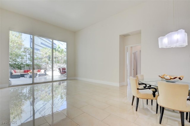 dining room featuring light tile patterned floors and baseboards