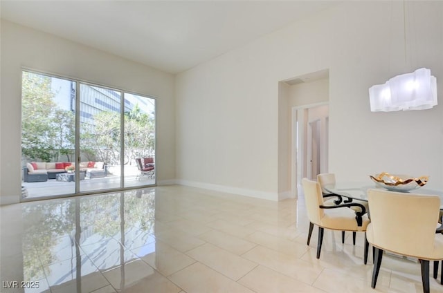 dining room featuring light tile patterned flooring and baseboards
