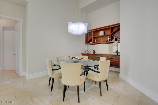 dining space with light tile patterned floors and baseboards