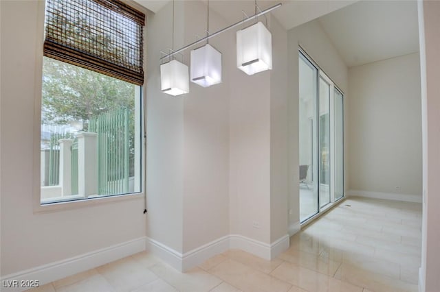 empty room with tile patterned floors and baseboards