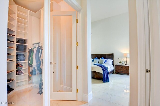 interior space with tile patterned flooring and a walk in closet