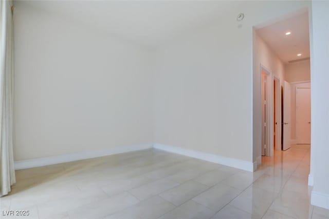 empty room with recessed lighting and baseboards