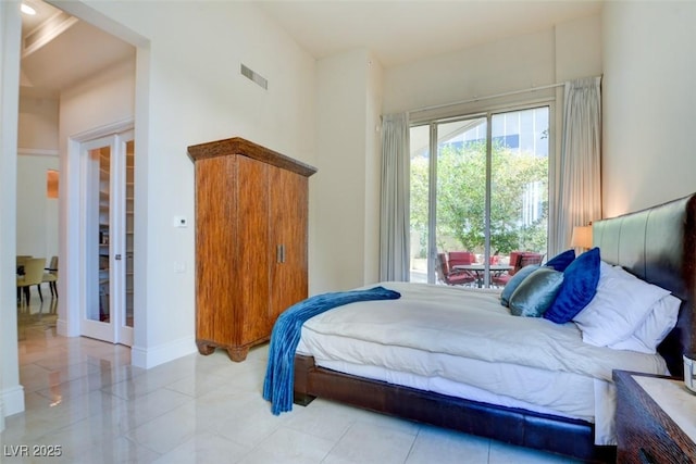 bedroom with baseboards, tile patterned flooring, and visible vents