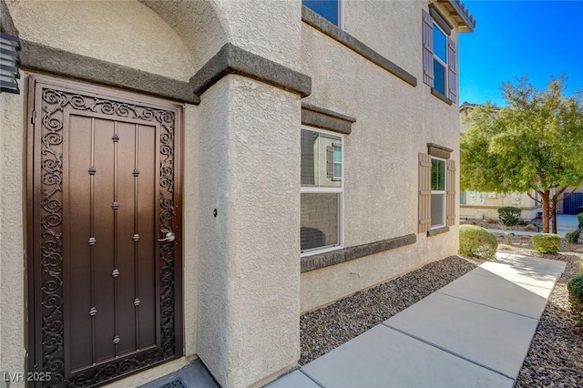 doorway to property with stucco siding