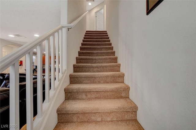 staircase with recessed lighting and visible vents