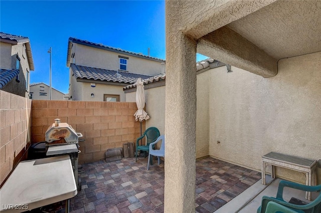 view of patio / terrace featuring a fenced backyard and a grill