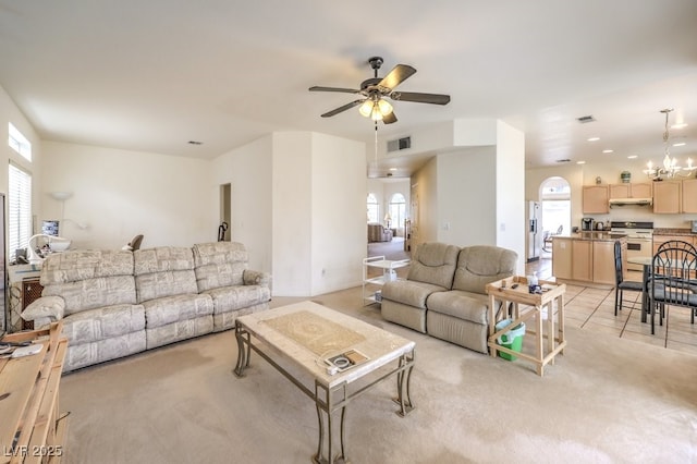 living area with a ceiling fan, visible vents, and light carpet