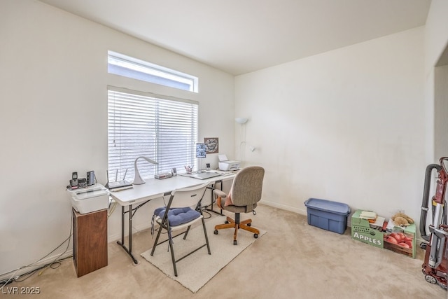 office space with baseboards and light colored carpet