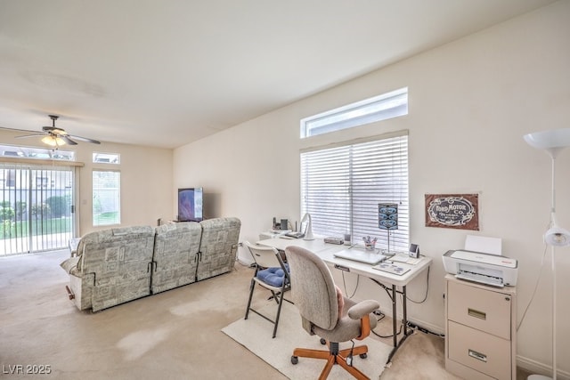 home office featuring a ceiling fan and light carpet