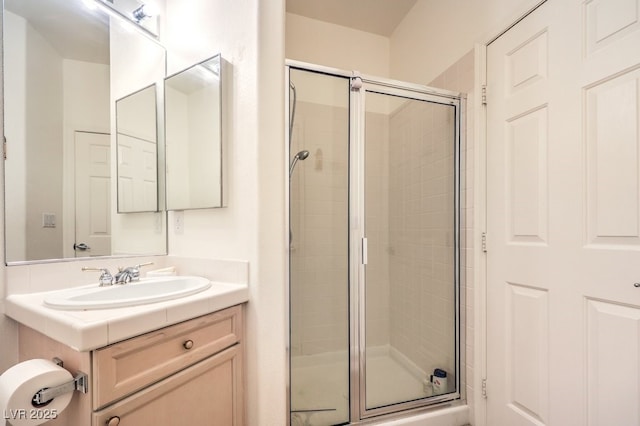 bathroom with a stall shower and vanity