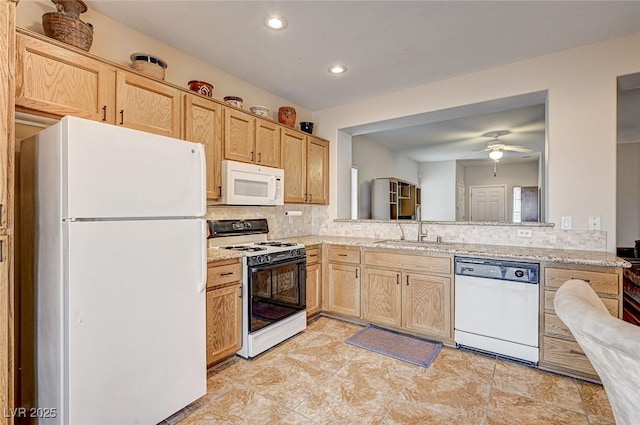 kitchen with decorative backsplash, white appliances, light brown cabinets, and a sink