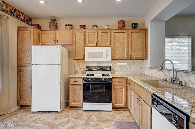 kitchen with white appliances, light stone counters, backsplash, and a sink