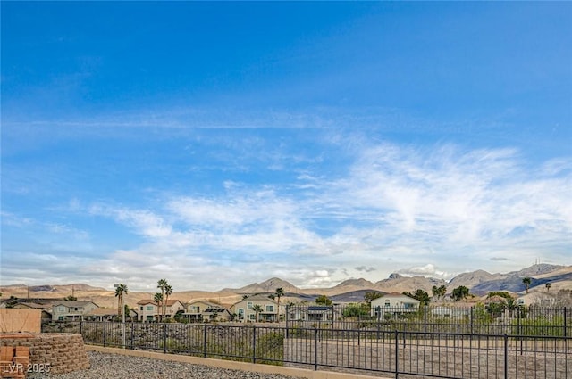 exterior space with a mountain view, a residential view, and fence