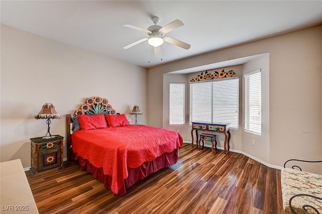 bedroom with ceiling fan, baseboards, and wood finished floors