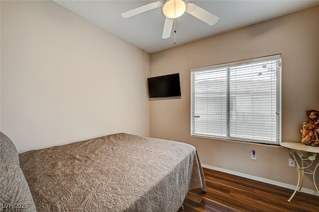 bedroom with ceiling fan, baseboards, and dark wood-style flooring