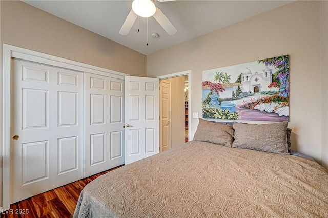 bedroom with ceiling fan, a closet, and dark wood finished floors