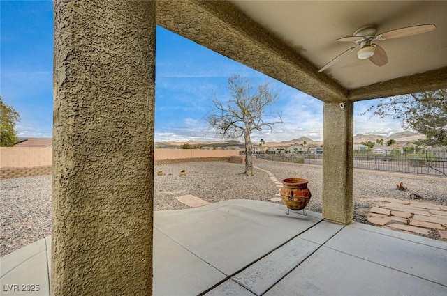 view of patio / terrace with a ceiling fan and fence