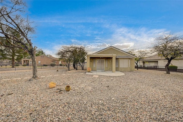 exterior space featuring a patio area, stucco siding, and fence