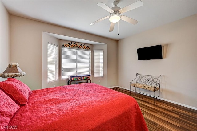 bedroom featuring wood finished floors, baseboards, and ceiling fan