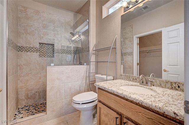 full bath featuring visible vents, toilet, tile patterned flooring, walk in shower, and vanity