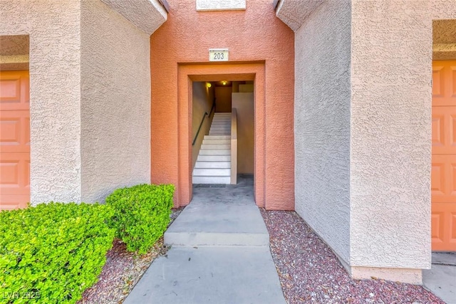 property entrance with stucco siding