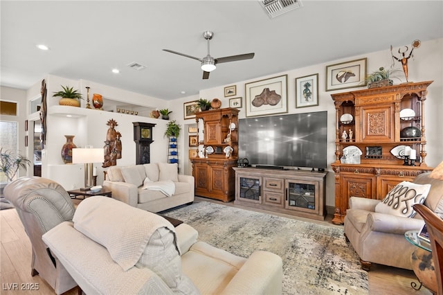 living area with recessed lighting, visible vents, light wood-style floors, and ceiling fan