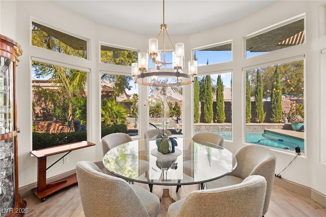 sunroom featuring a notable chandelier