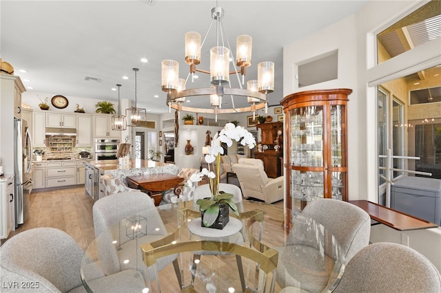 dining room featuring recessed lighting, visible vents, an inviting chandelier, and light wood finished floors