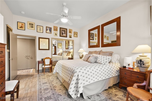 bedroom featuring light wood-type flooring and a ceiling fan