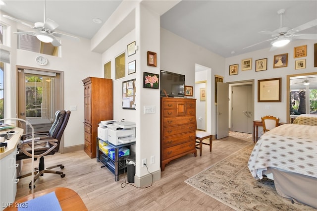 bedroom featuring a ceiling fan, baseboards, and light wood finished floors