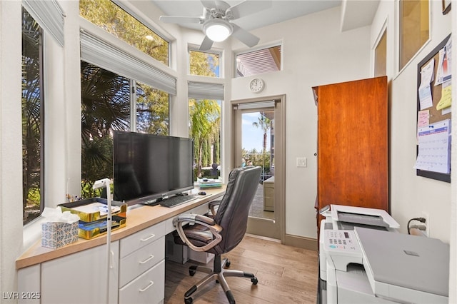 office area with light wood-style flooring, baseboards, and ceiling fan