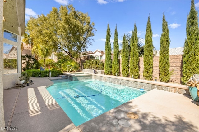 view of swimming pool featuring a patio area, a fenced backyard, and a pool with connected hot tub