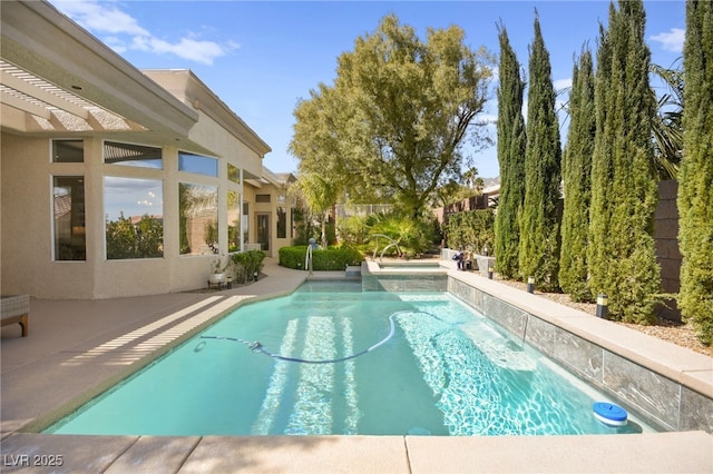 view of swimming pool featuring a patio area and a pool with connected hot tub