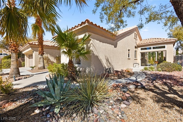 view of home's exterior with a garage and stucco siding