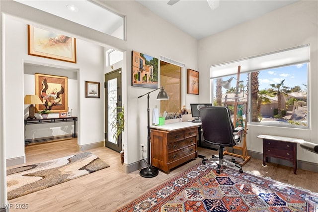 office area featuring ceiling fan, baseboards, and wood finished floors