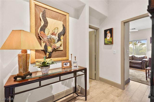 hallway with baseboards and light wood-type flooring