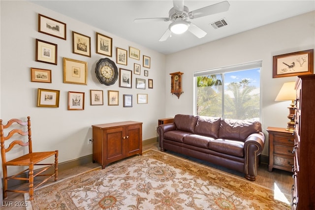 sitting room with visible vents, baseboards, ceiling fan, and wood finished floors