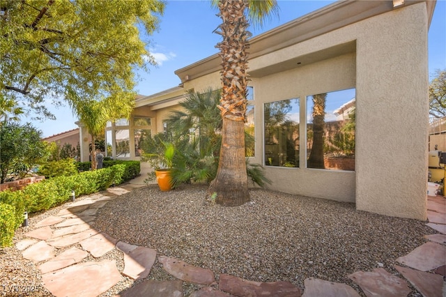 view of side of property with stucco siding