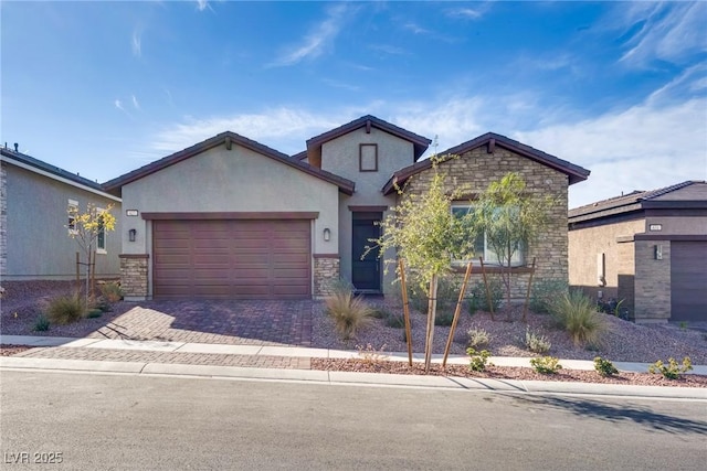 view of front of property with stone siding, stucco siding, decorative driveway, and a garage