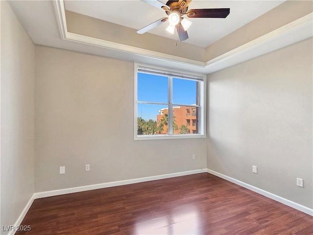 unfurnished room with wood finished floors, baseboards, and ceiling fan