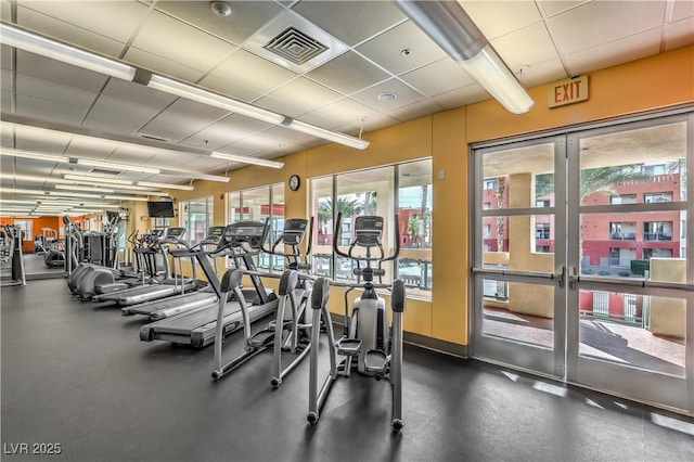 exercise room with visible vents and a drop ceiling