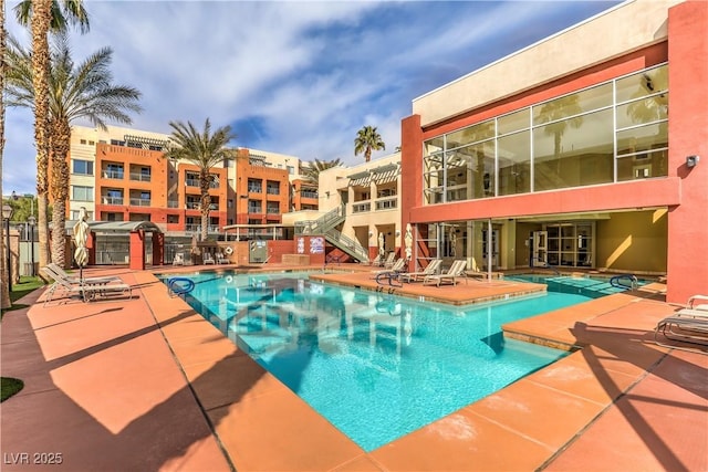 pool with a patio and fence