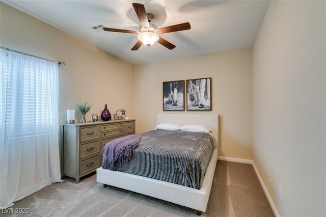 bedroom featuring light carpet, baseboards, and a ceiling fan