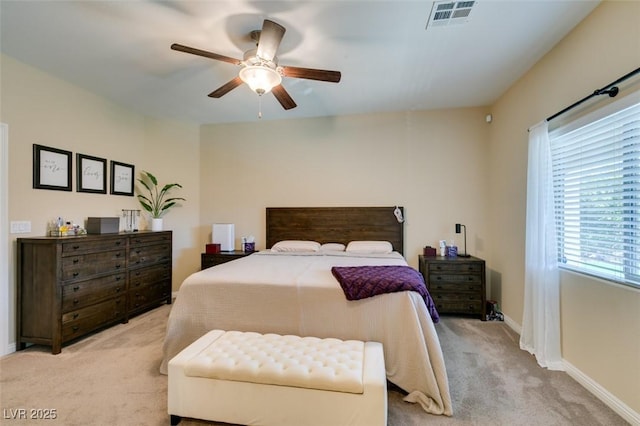 bedroom featuring a ceiling fan, baseboards, visible vents, and light carpet