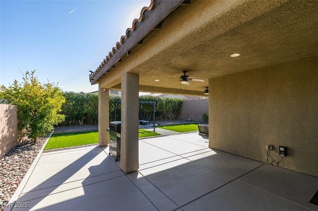 view of patio with a fenced backyard and a ceiling fan