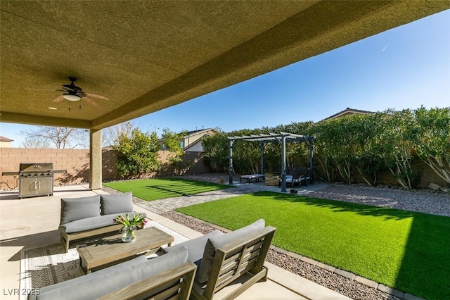 view of patio with an outdoor living space, area for grilling, a fenced backyard, and ceiling fan